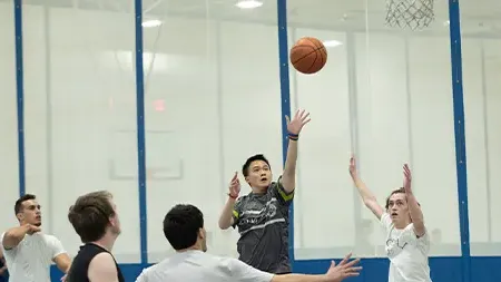 Group of male students playing intramural 篮球 game